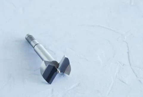 Forstner drill on a concrete gray background. Close-up. Stock Photos