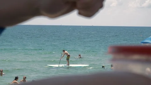 Fort laudaurdale beach,FL:boy driving a paddle board in a beautiful summer day Stock Footage 93673888