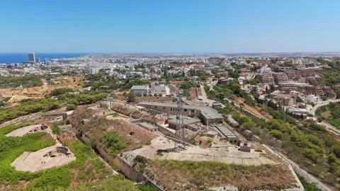 Fort Madliena radar towers above Malta's Mediterranean coast aerial view Stock Footage 340111053