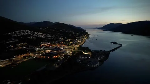Fort William drone hyperlapse at dusk with train, traffic and boat Stock Footage 330590762