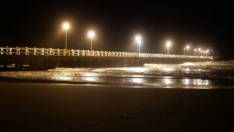 Forte dei Marmi: Pier in rough seas at night, street lights on Stock Footage 121843543