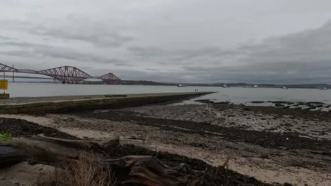 Forth estuary coastline with Forth Rail Bridge in the distance Stock Footage 323082298