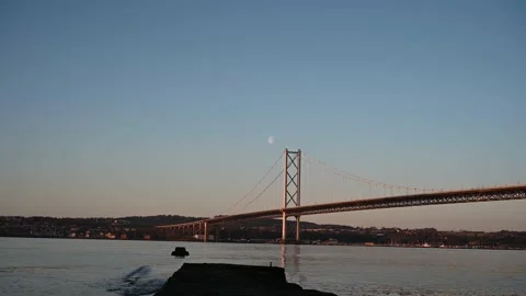 Forth Road Bridge with moon at sunrise Stock Footage 151504674