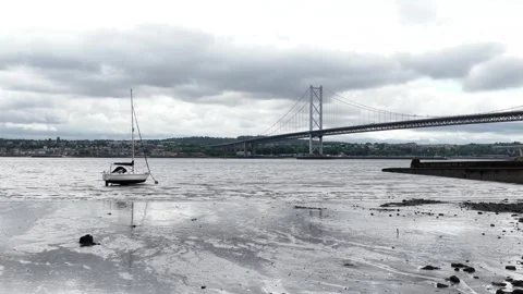 Forth road bridge view with sailboat during low tide Stock-Footage 342436821
