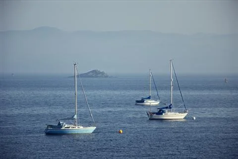 Forth view with yachts at anchor and a small island Stock Photos