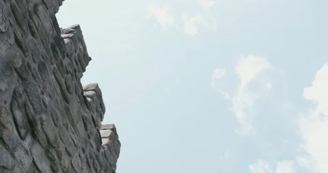 Fortified fortress wall seen from the bottom up and a clear blue sky with wh Stock Footage 166316408