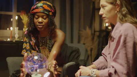 Fortune Teller Answering Questions with Help of Crystal Ball Stock Footage 247631938