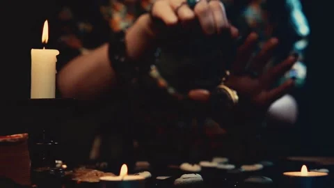 The fortune teller casts a spell over the runes with the help of the amulet. 스톡 동영상 217782018