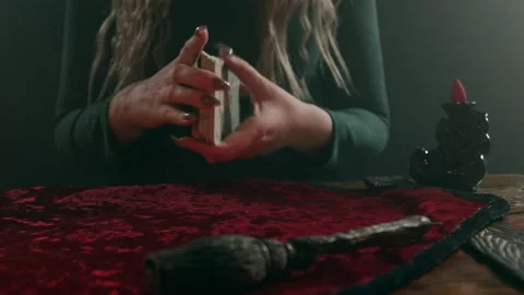 A fortune teller conducts a divination session on tarot cards. Video stock 192927117