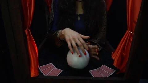 Fortune teller conjuring using a crystal ball and cards Stock Footage 101370151