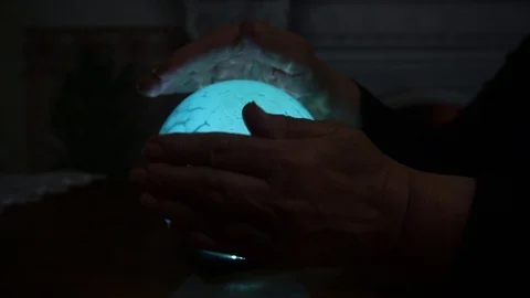 Fortune teller does magic with a luminous ball. Stock Footage 123017023