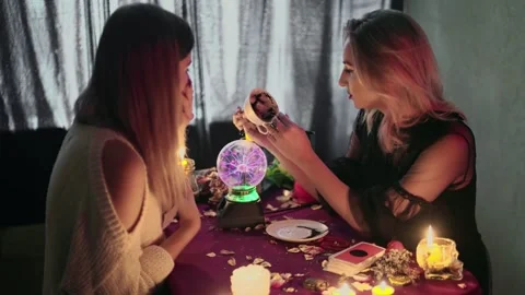 Fortune teller explains fortune on Turkish coffee to her young client Video stock 143513995