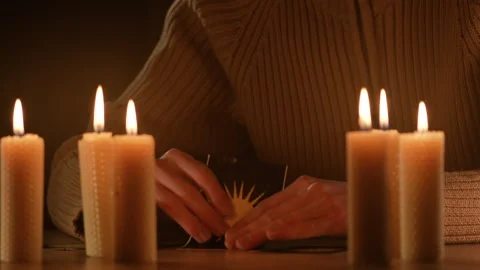Fortune teller hands under candles fortune-telling on tarot cards. Stock Footage 329306091