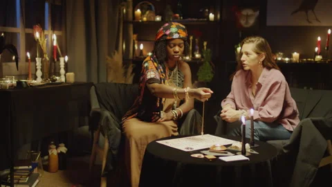 Fortune Teller Having Session with Pendulum Predicting Clients Future Stock Footage 247629490