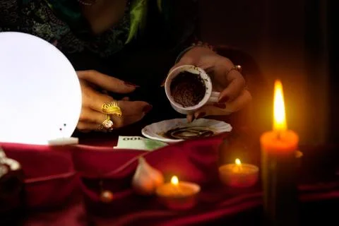 Fortune teller holds an empty coffee mug Stock Photos