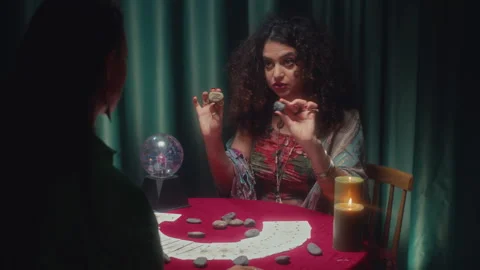 Fortune Teller Laying out Rune Stones on Table during Prediction Session Stock Footage 253181729