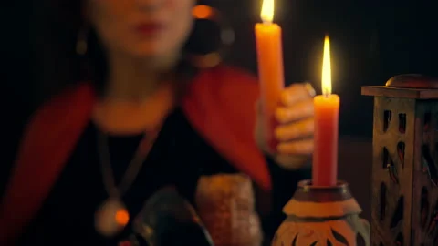 Fortune-teller lighting candle while forecasting future for client, occultism Stock Footage 170816729