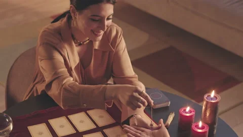 Fortune Teller with Pendulum and Tarot Cards Reading Palm of Woman Stock Footage 201299778