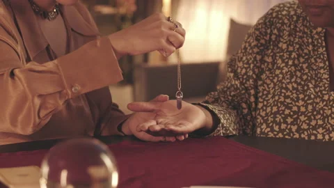 Fortune Teller with Pendulum Conducting Palm Reading Stock Footage 201300193
