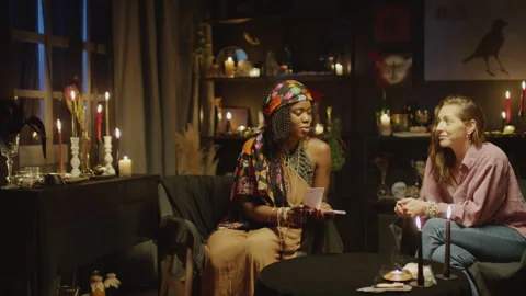 Fortune Teller Predicting Clients Future with Tarot Cards Stock Footage 247628773