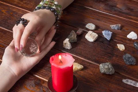 Fortune teller predicts fate using a magic ball, stones and a lit candle.A Gy Stock Photos