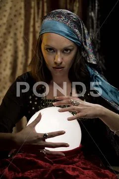 Fortune teller psychic gypsy at crystal ball Stock Photos