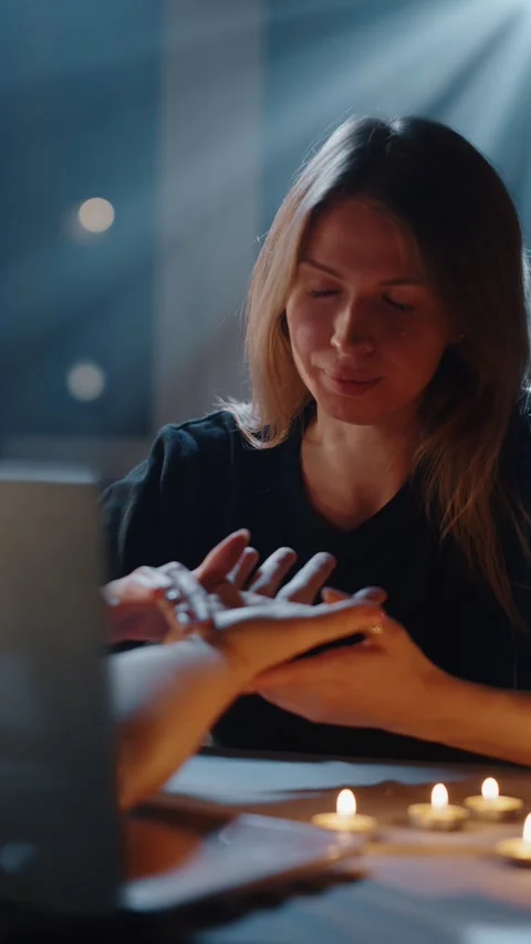 Fortune teller reading palm by candlelight 스톡 동영상 316824452