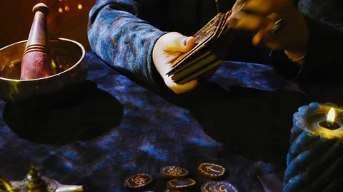 A fortune-teller reads tarot cards on a dark velvet table by candlelight in the Stock Footage 236248657