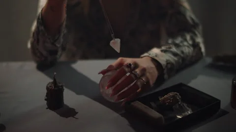 Fortune teller spins pendulum in hands, magic rituals Stock Footage 305793738