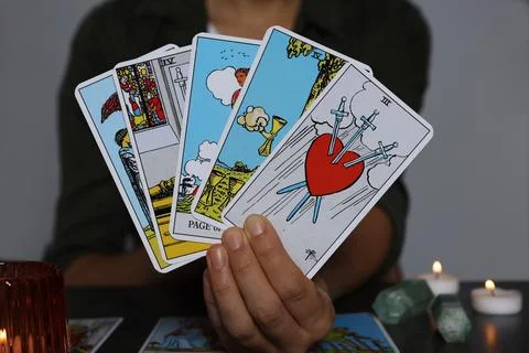 Fortune teller with tarot cards at grey table indoors, closeup Stock Photos