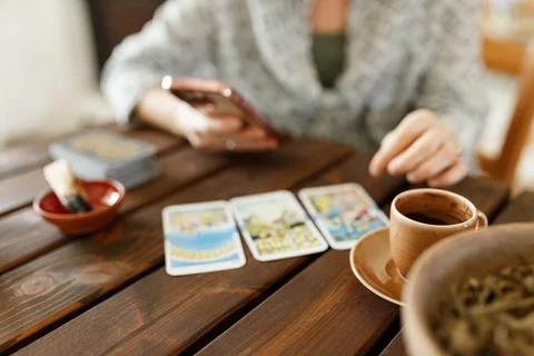 Fortune teller with tarot cards on table near burning candle.Tarot cards spread Stock Photos