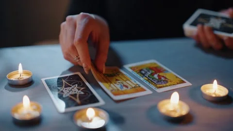 Fortune teller tarot reader lays out cards in order Video stock 306016090