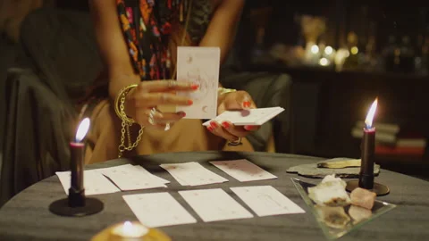 Fortune Teller Thinking about Tarot Cards Meaning during Layout Stock Footage 247635726