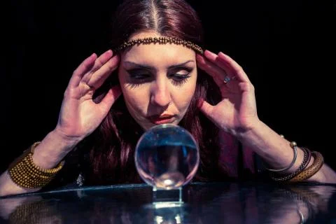 Fortune teller using crystal ball with eyes closed Stock Photos