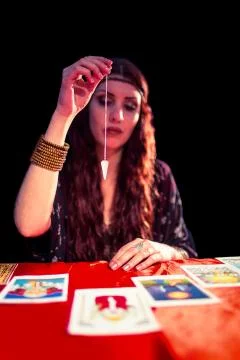 Fortune teller using pendulum Stock Photos