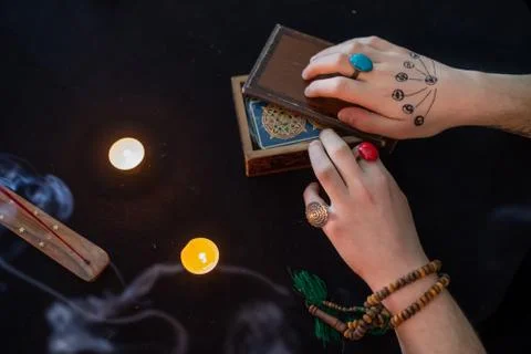 Fortune teller using tarot cards on black background Stock Photos