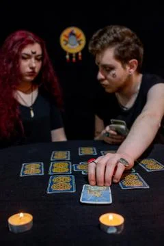 Fortune teller using tarot cards on black background Stock Photos