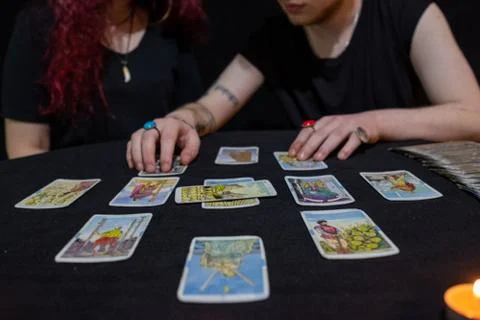 Fortune teller using tarot cards on black background Stock Photos