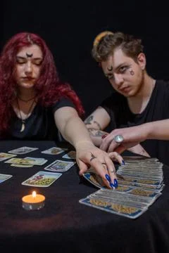 Fortune teller using tarot cards on black background Stock Photos