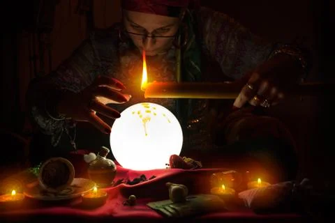 Fortune teller witch holding candle Stock Photos