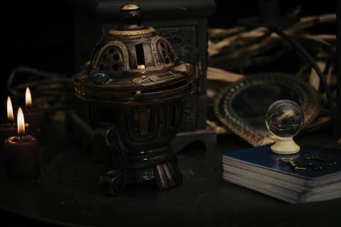 A fortune teller, witch stuff on a table, candles and fortune-telling objects Stock Photos