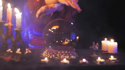Fortune teller without a face read the future in a crystal ball Stock Footage 169655906