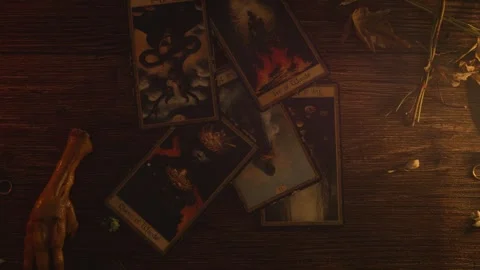 Fortune teller's hand spreading an array of detailed tarot cards and spiritual Stock Footage 318870725