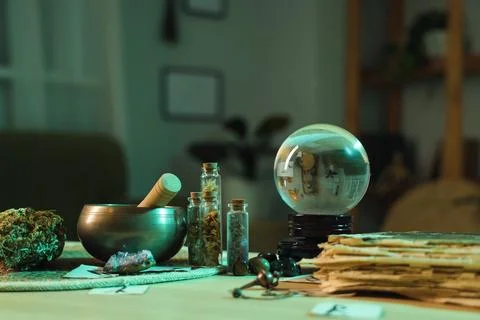Fortune teller's magic attributes on table in dark room, closeup Stock Photos
