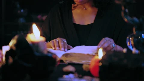 Fortuneteller reading magic spell book, learning ancient healing ritual, witch Stock Footage 201331457