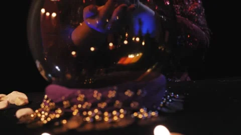 A fortuneteller without a face in the salon read the future in a crystal ball an Stock Footage 169656023