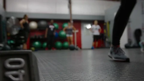Forty pound dumbbell rack focus to women working out executing walking Stock Footage 95942349