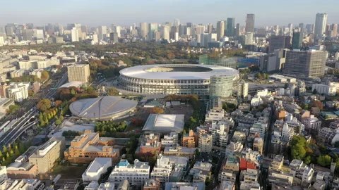 A forward 4k drone dolly shot of the Japan National Stadium and the Tokyo Stock-Footage 141138920