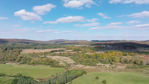 Forward Aerial Drone Flight Over Autumn Farmland and Rolling Hills Stock Footage 321377558