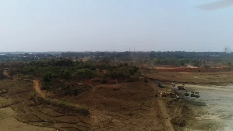 Forward aerial drone view of excavators and dump trucks on construction site Stock Footage 346196573